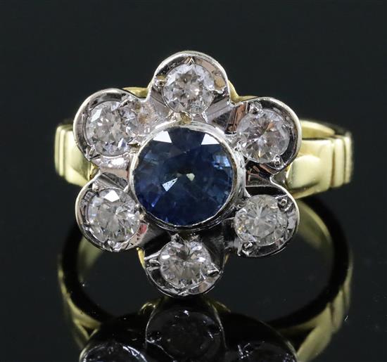 A modern 18ct gold, sapphire and diamond seven stone flowerhead cluster ring, size J/K.